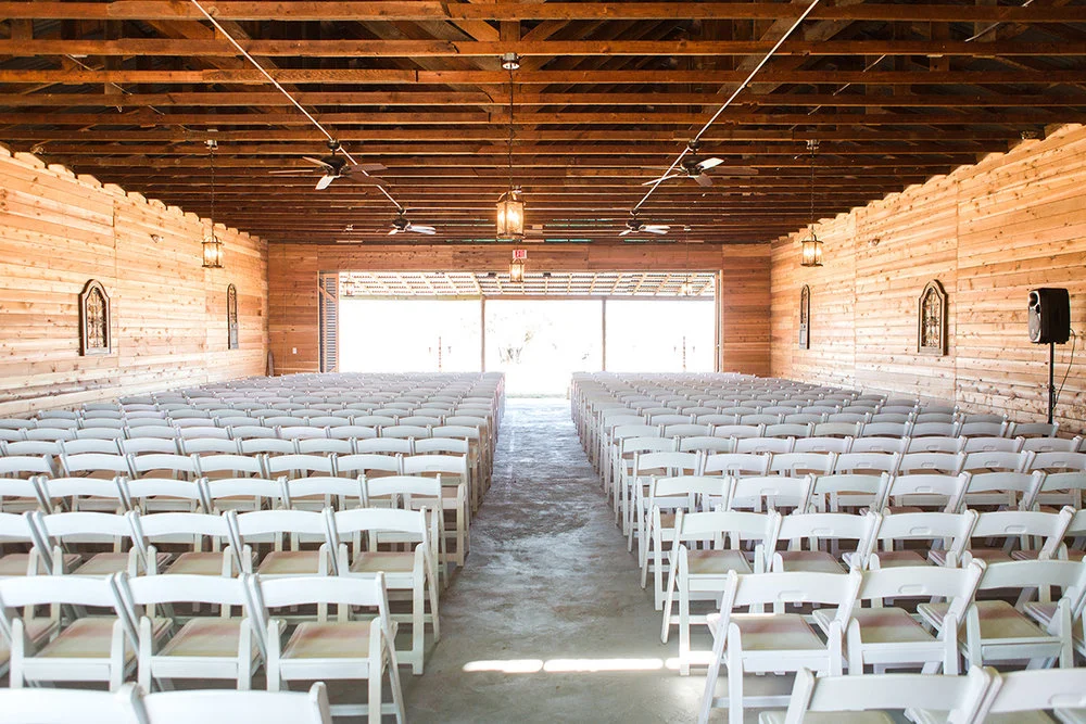Barn Interior with Chairs Arranged for Ceremony.