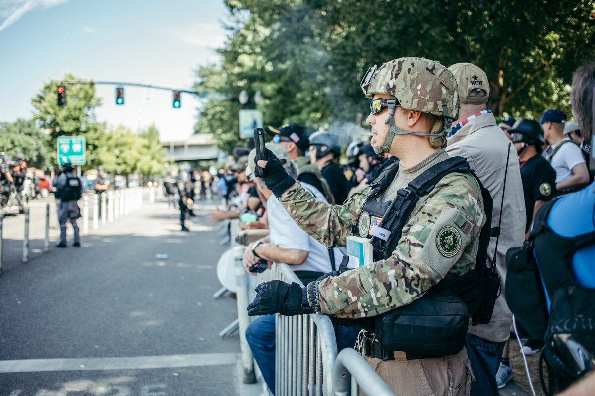 Photo from Willamette Week , depicting a Three Percenter vaping at a rally in Portland. While the current situation in Oregon almost went much worse, it is possible that the situation in that state is a suggestion of things to come.