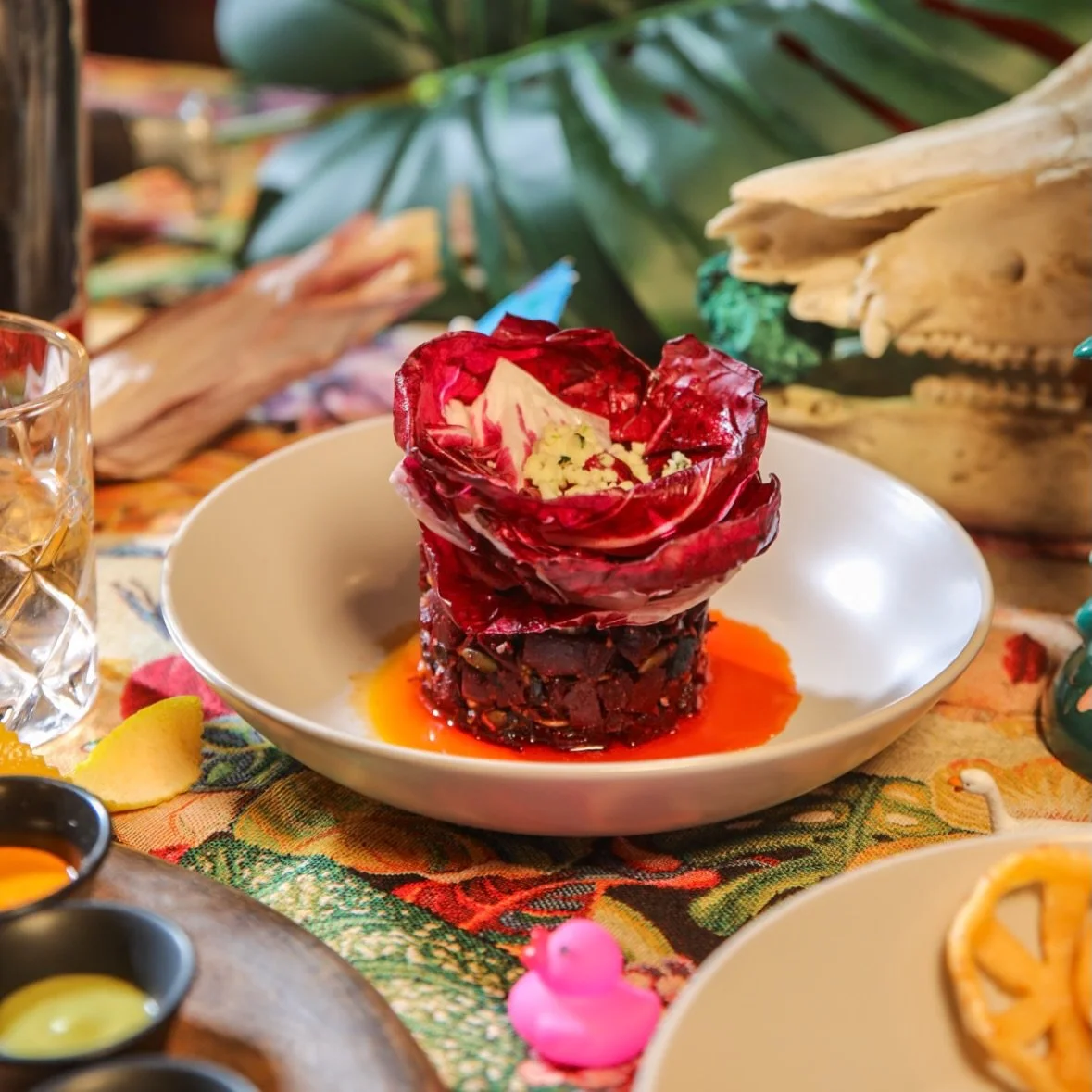 Charred beets, transformed through nixtamalization, a time honored Mesoamerican process that builds depth and bite, layered with radicchio, botanero, salsa macha, and bright escabeche. 

Bold, cultured, and just a little spicy. 🔥😈

📸 @_castellan0s