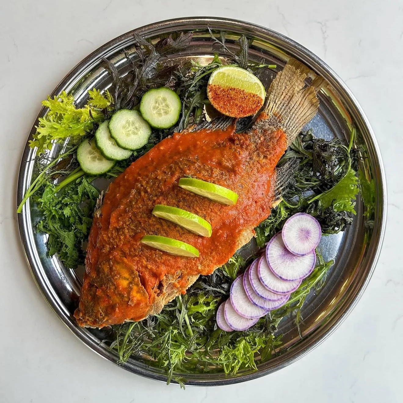 Mojarra a la Diabla: crispy whole tilapia living its best life, absolutely drenched in salsa roja, with mustard greens and a fresh little salad to keep things balanced

Tortillas on deck. Napkins recommended. Regrets? Not invited.