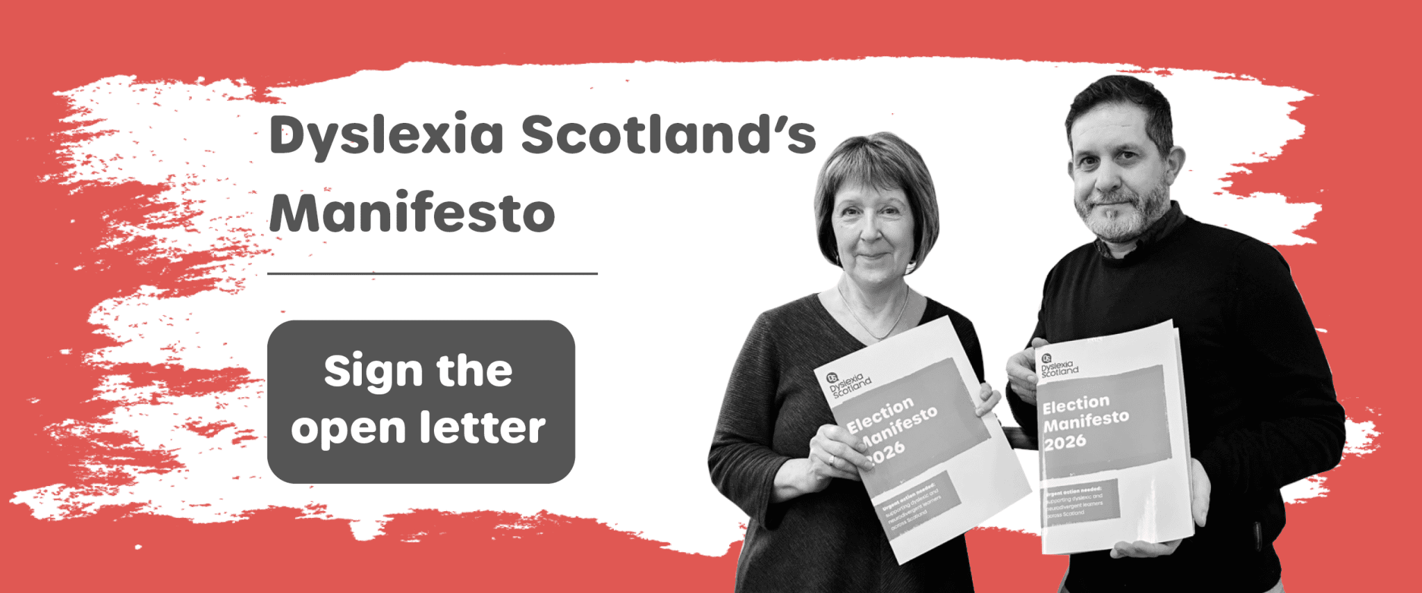 Dyslexia Scotland CEO Cathy Magee stands beside Dyslexia Scotland Ambassador Paul McNeill holding the Dyslexia Scotland Manifesto 2026 urging people to sign the Dyslexia Manifesto Open Letter