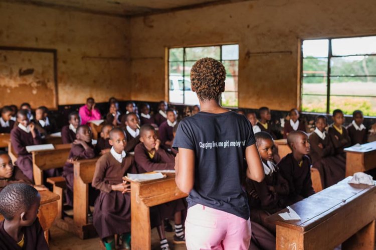 A addressing a classroom of school girls