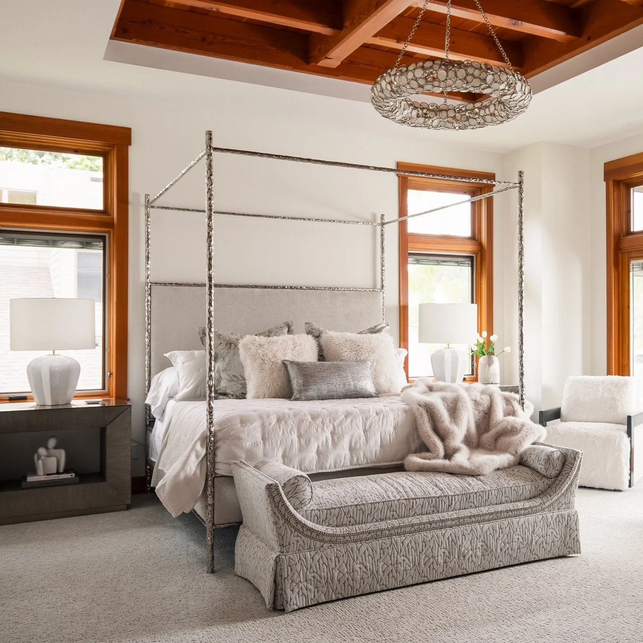 At Grandview, the view was always going to lead &mdash; so we let it. In the primary suite, the palette stays quiet. The materials &mdash; hammered metal, velvet, fur, and warm wood &mdash; bring the cozy. The sculptural canopy bed is the defining mo