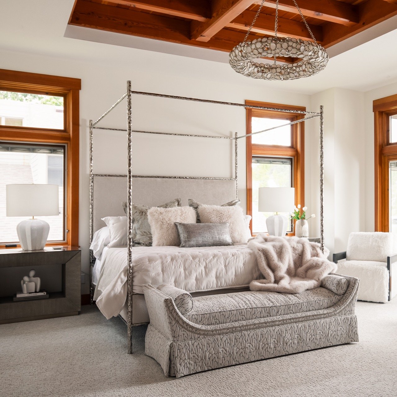 At Grandview, the view was always going to lead &mdash; so we let it. In the primary suite, the palette stays quiet. The materials &mdash; hammered metal, velvet, fur, and warm wood &mdash; bring the cozy. The sculptural canopy bed is the defining mo