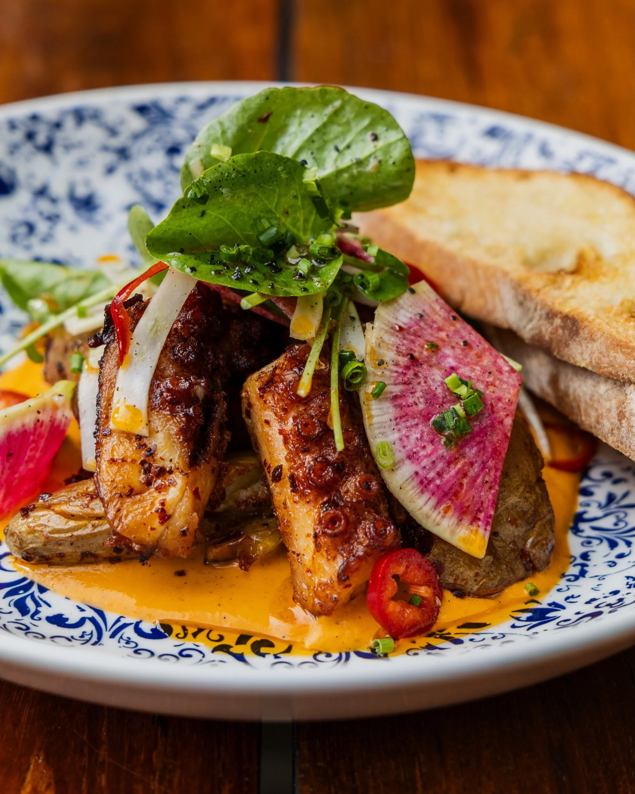 Wood-fired and built for summer. Spanish octopus with fennel, Fresno chile, crispy potato, red pepper emulsion and toast.
