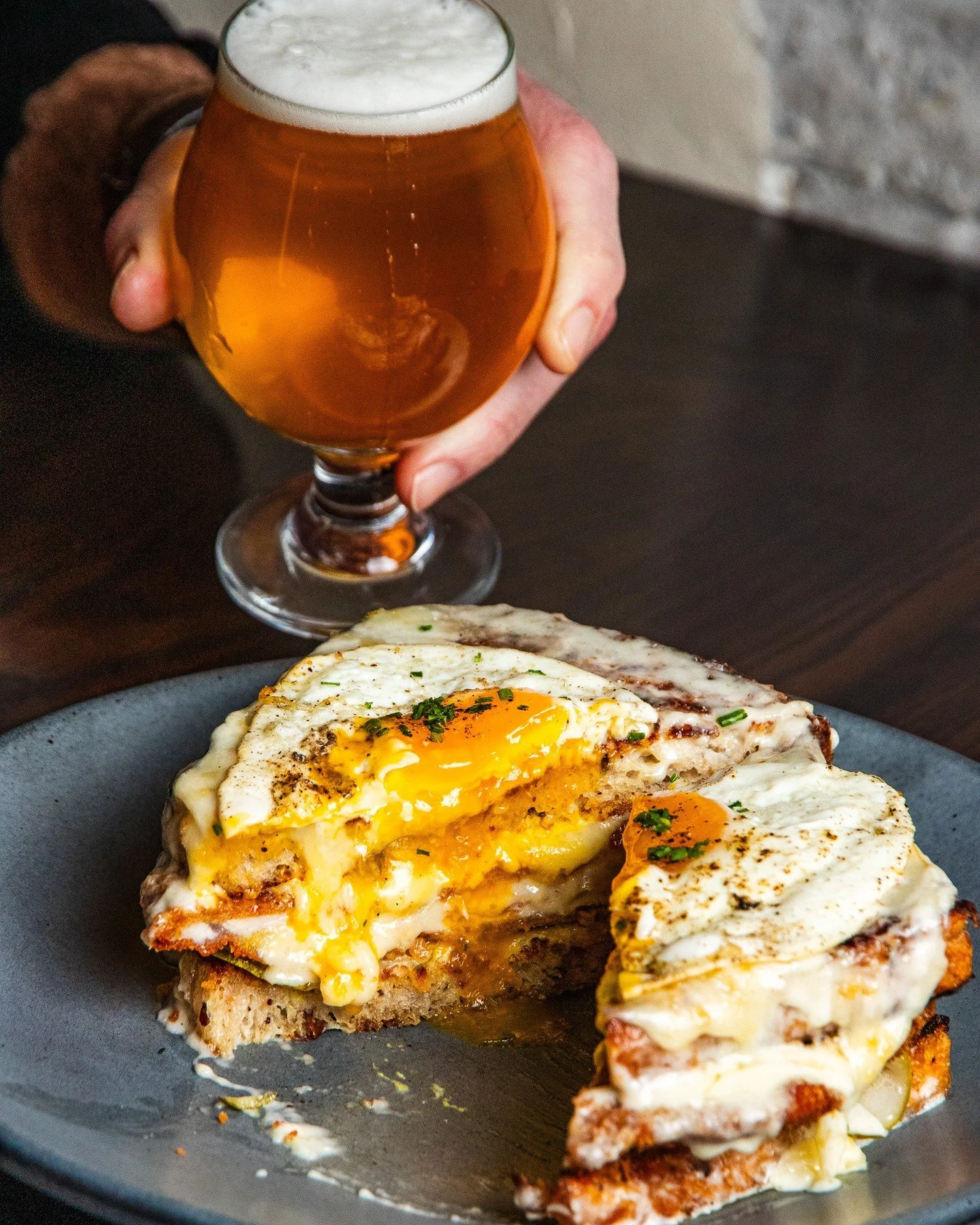 The Croque Cubano 🍳⁠
⁠
Pork milanese, Nueske&rsquo;s ham, gruy&egrave;re, pickles, mornay sauce, and a sunny side up egg on Publican bread.