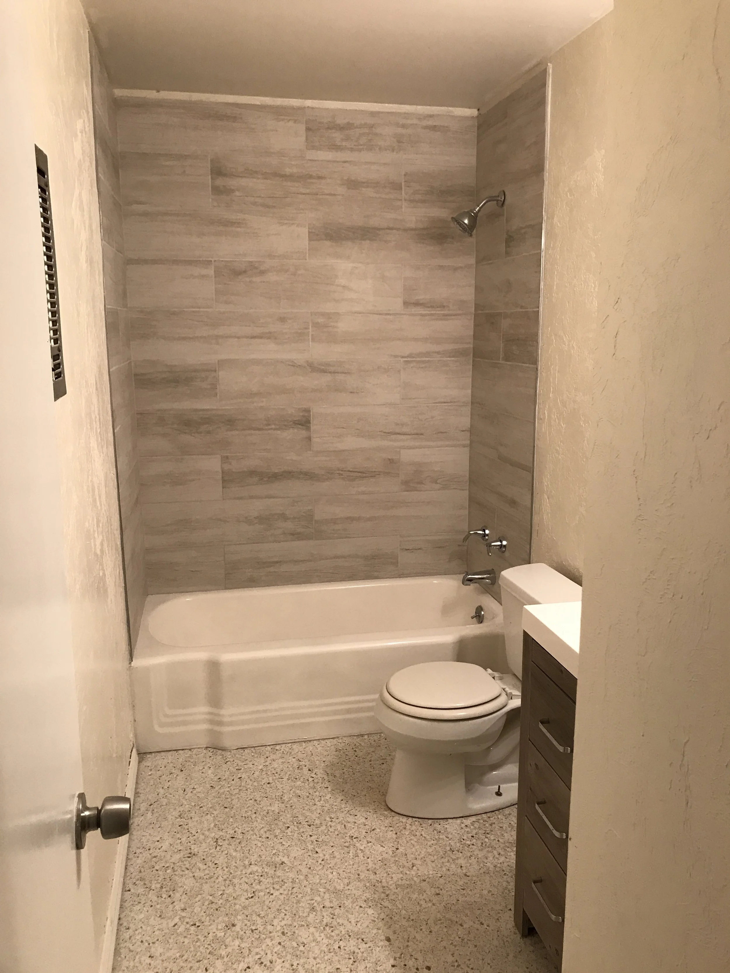 Finished bathroom: tile, vanity installed, bathroom walls and trim painted