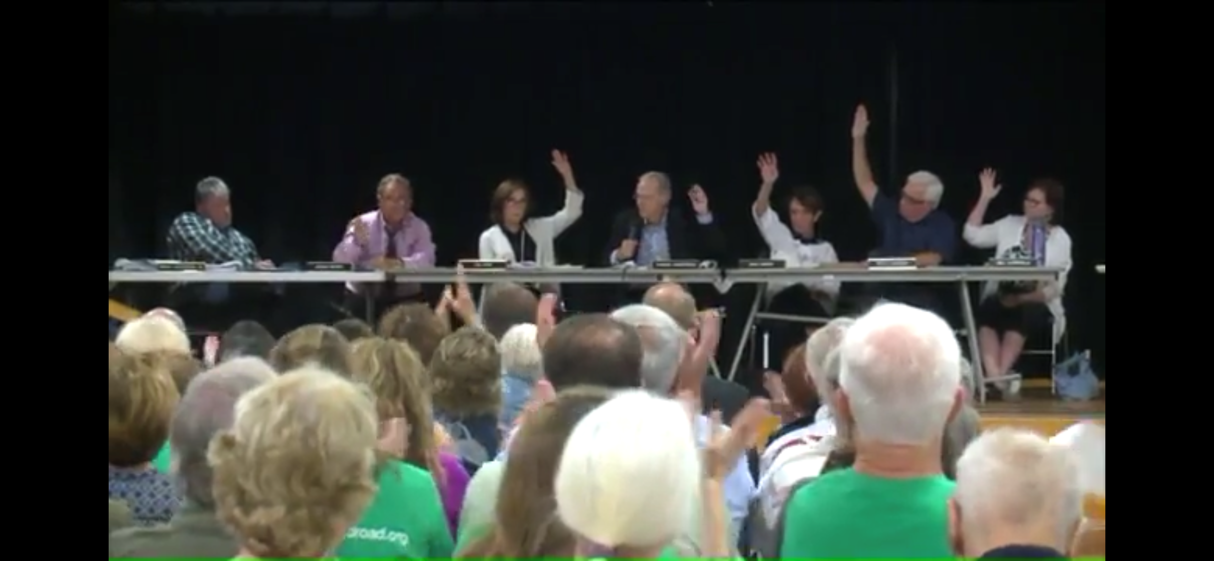 6 commissioner raise their hand to vote against the zone change. 1 does not.