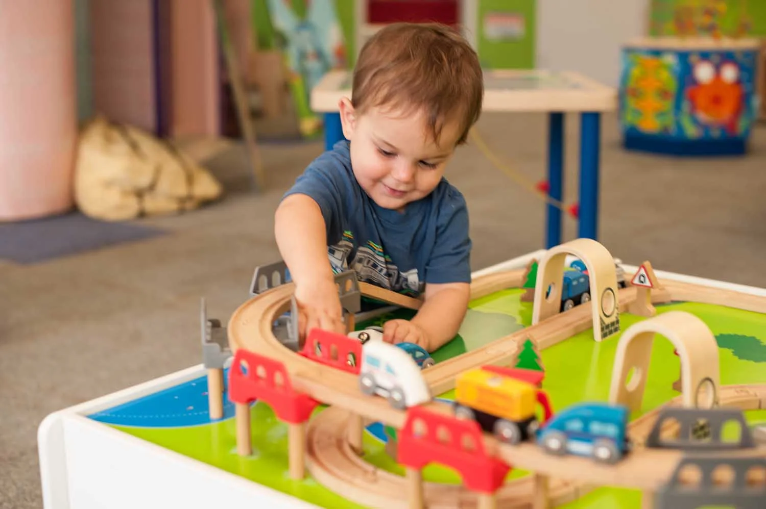 kid-playing-hape-train-table.jpg