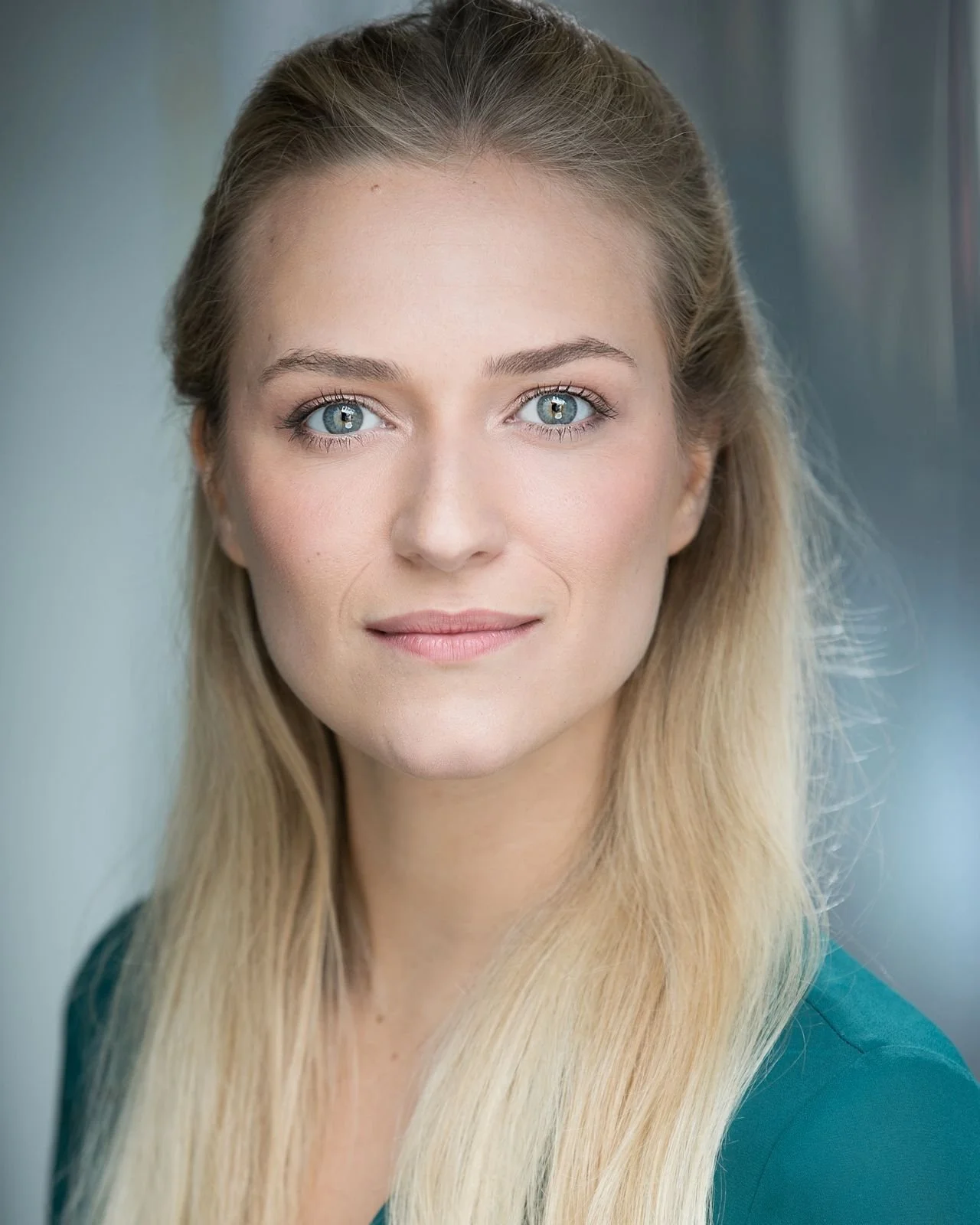 Octavia Gilmore, headshot photo, wearing a teal top, against a blurred background.