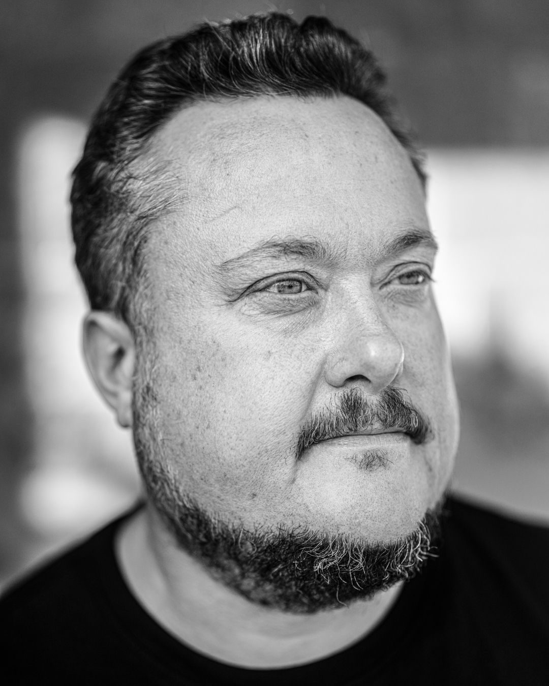 Matt Sparkes, headshot photo, slicked-back hair, looking slightly to the side.