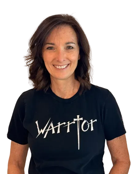 Tamara smiling, wearing a black t-shirt with the word 'Warrior' and a sword graphic.