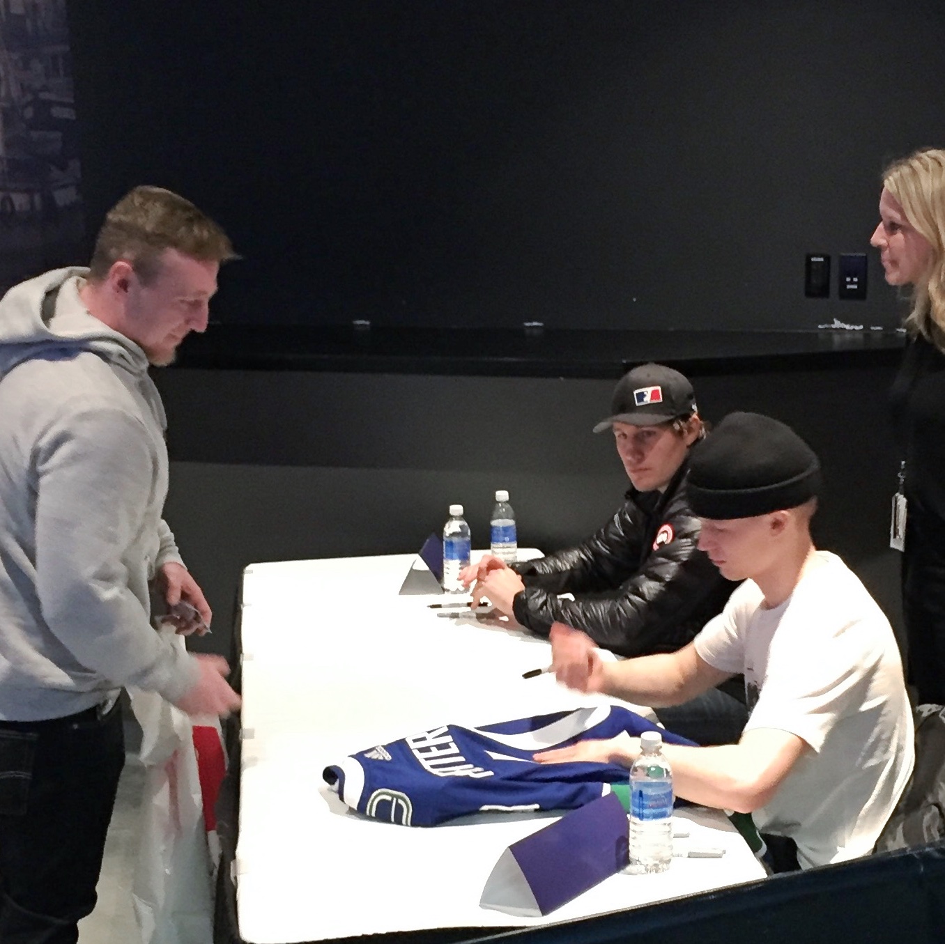 A tiny Pettersson signs autographs at Canucks Season Ticket Holder event