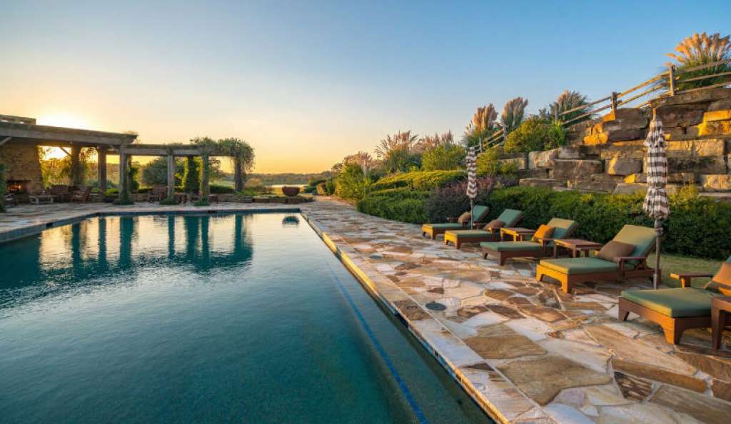  Extensive landscaping, green spaces, and stone masonry serve to ground this expansive project in its hearty Texas roots. 