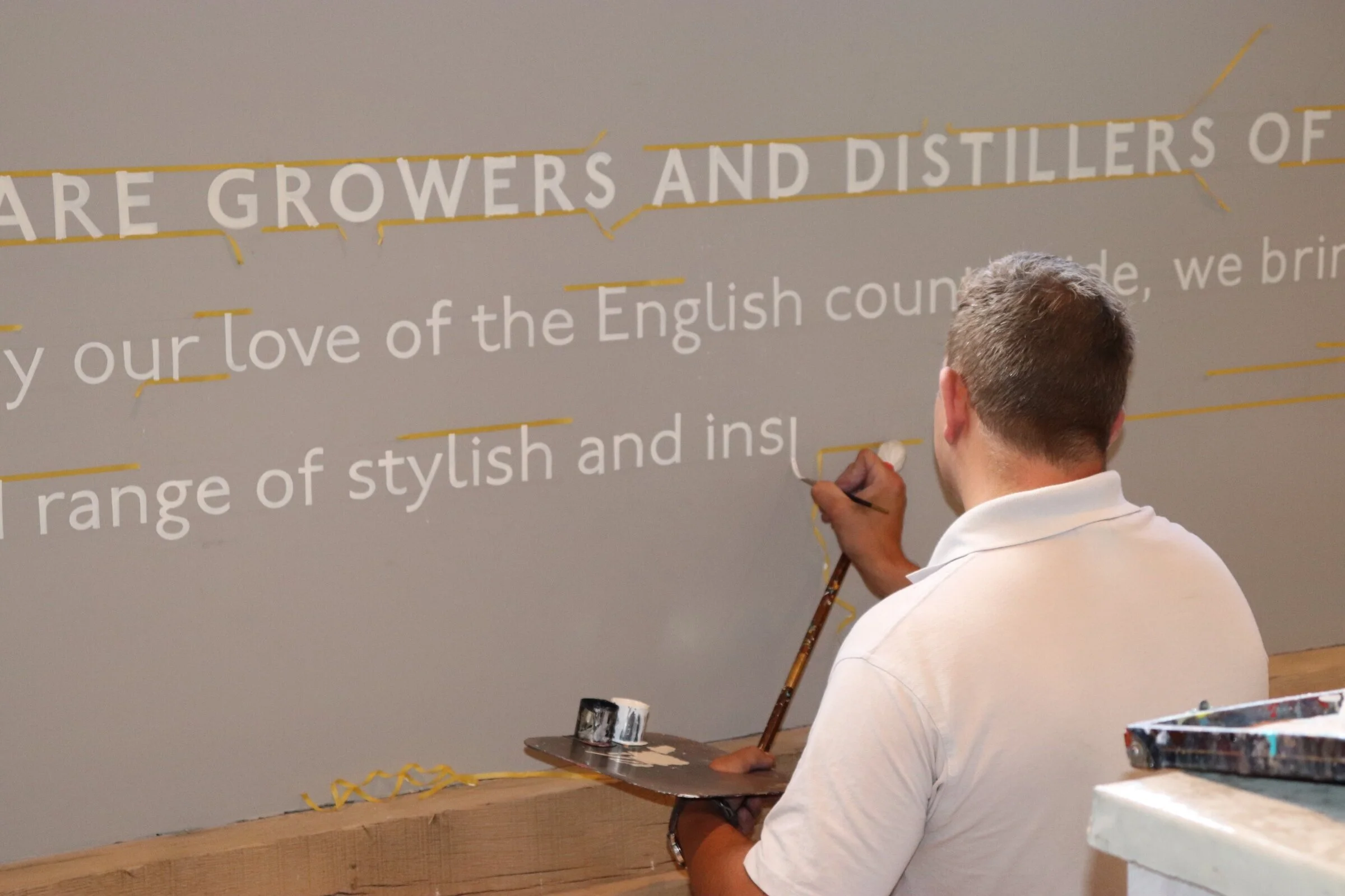  We created a welcome area and commissioned a local sign writer to hand paint Long Barn’s brand statement on the walls next to a large scale vinyl seasonal wall graphic within the shop. 