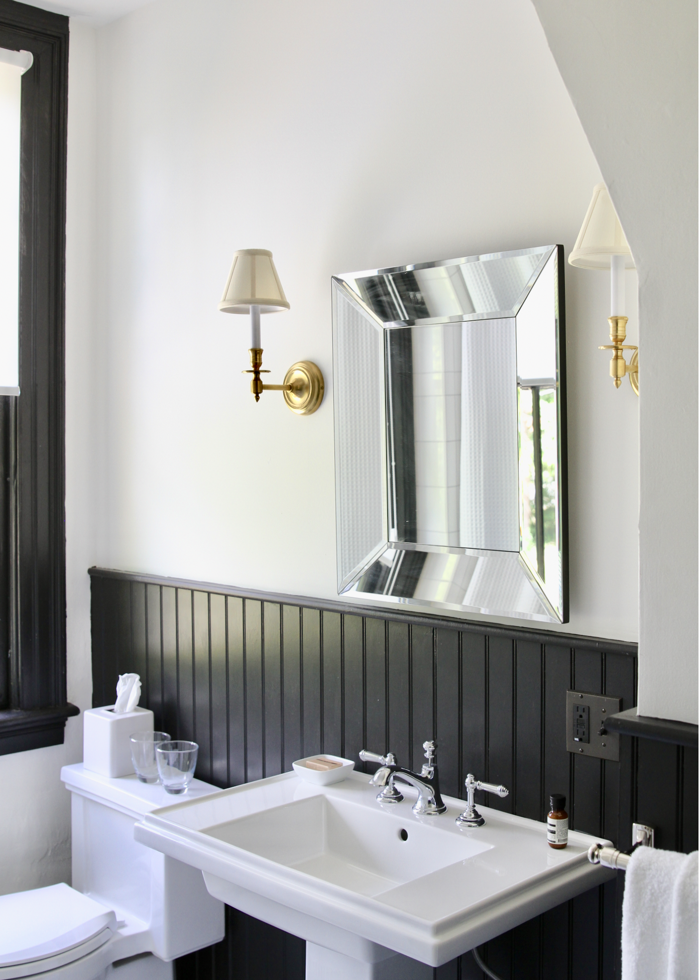 Room Five A spacious Bathroom features a cast iron bathtub with shower, and radiant heated mosaic tile floors. Black trim and wainscoting adds a bit of drama. Toiletries are Aesop .