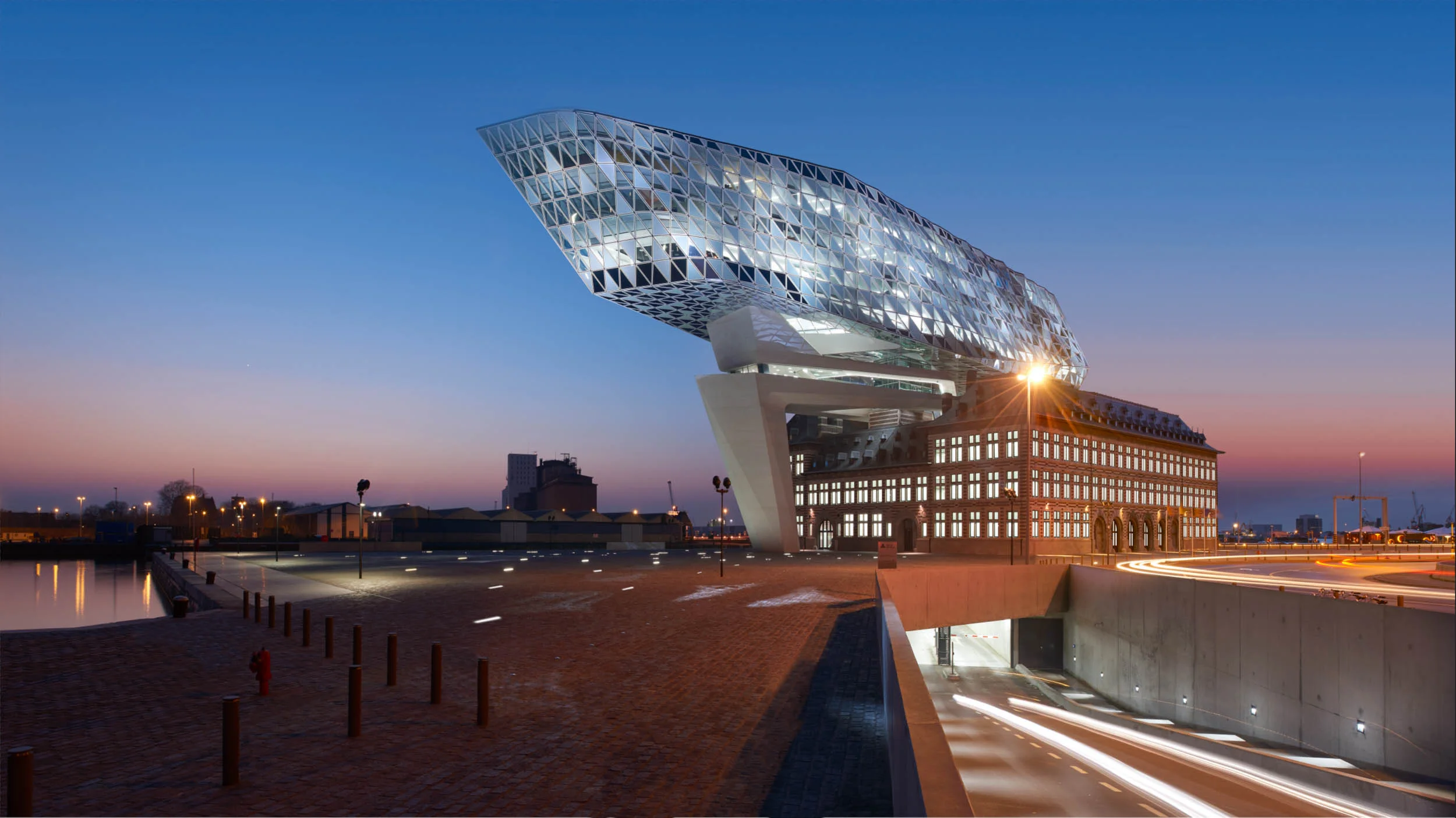  Antwerp Port Authority by Zaha Hadid Architects // photography: Maarten Stappaerts #ZahaHadid #modern #architecture #architecturephotography archiphoto #exterior #PortAuthority #PortOfAntwerp #Antwerp #lighting #InverseLightingDesign #twilight #Qual