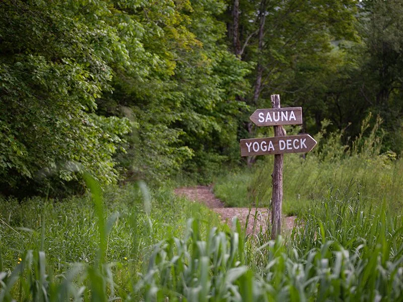 Rustic signs to the Sauna & Yoga Deck at Roxburys Bellfire in the Catskills