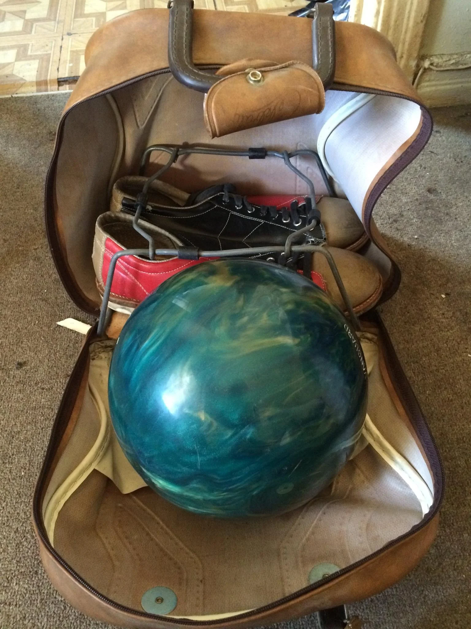 Of everything we've given him and he's lost, ruined or given back, this is the single thing Nick kept safe and in perfect condition. It is the vintage bowling ball and shoes Craig gave him for his sixteenth birthday. He insisted on carrying them on the plane.