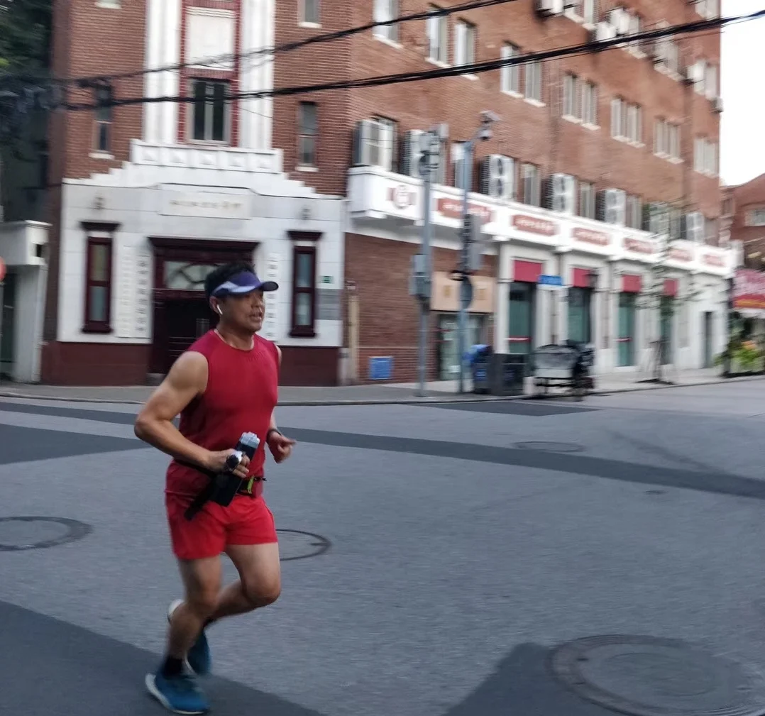 Steven running on empty streets in Shanghai at 6:00 AM