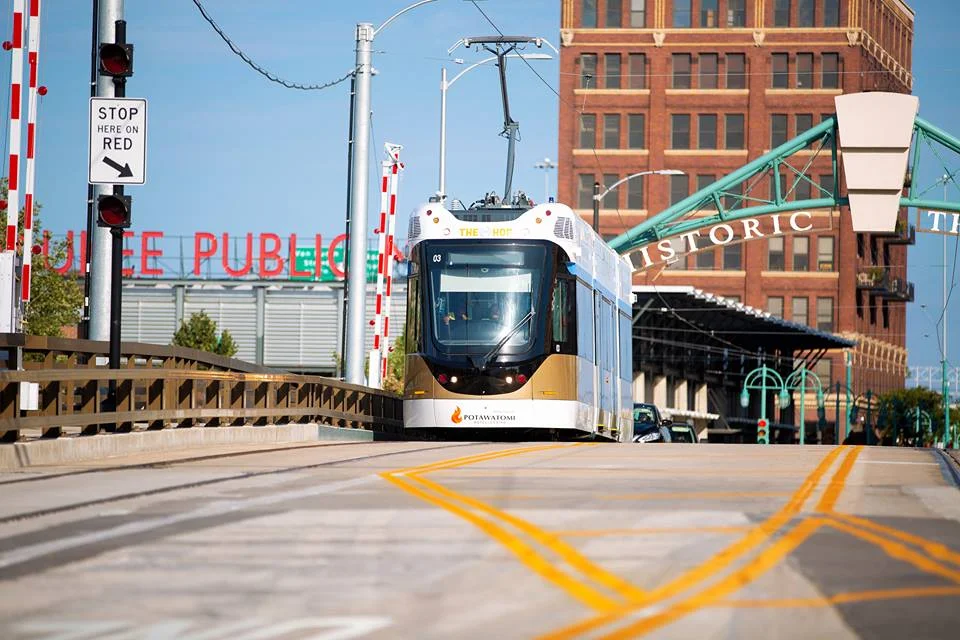 Milwaukee Streetcar (The Hop) traveling down a street in Milwaukee with the Milwaukee Public Market in the background.