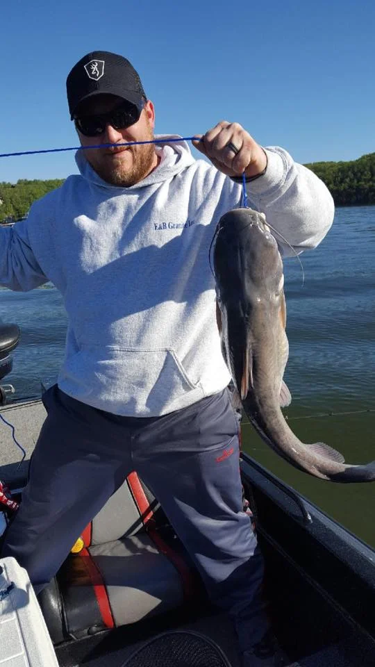 IMAGE OF FISHERMAN WITH CATFISH