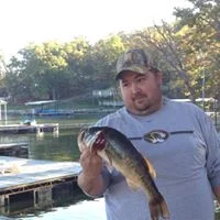 IMAGE OF MAN HOLDING FISH