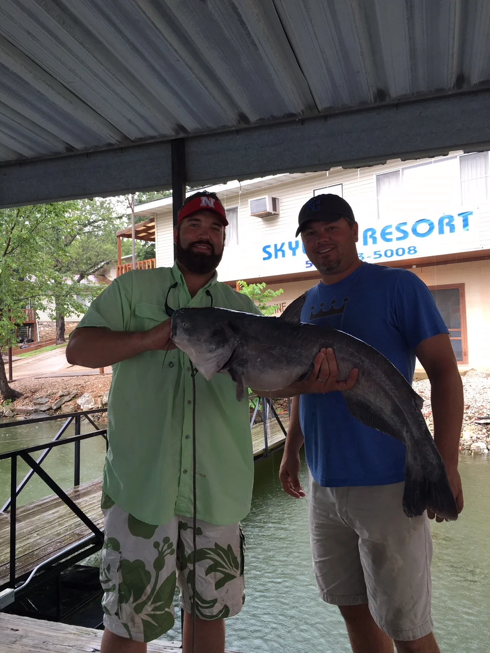 IMAGE OF TWO GUYS HOLDING CATFISH