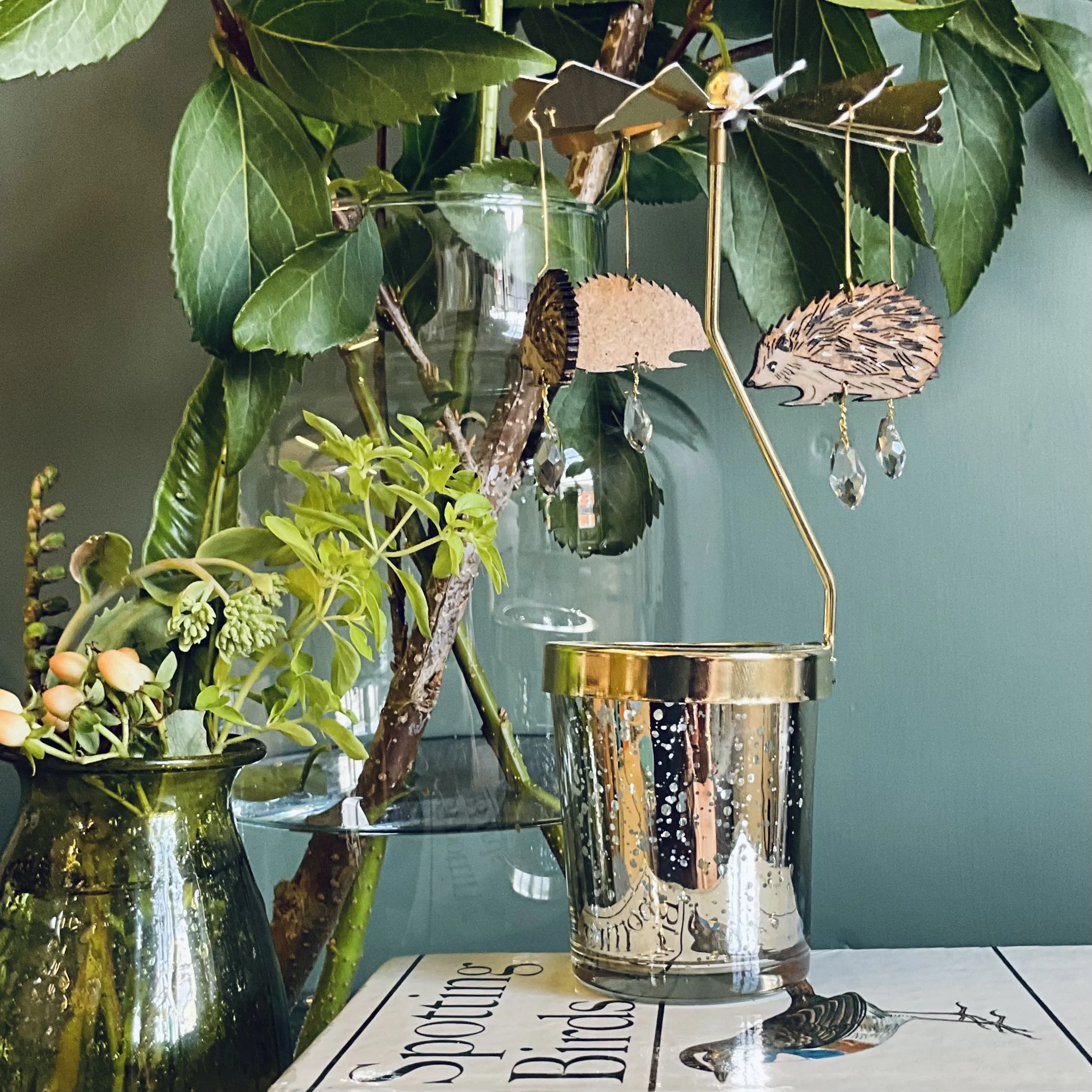 Four prickly hedgehogs are elegantly suspended from a brass propeller, with the heat from a tea light candle they start to spin. (Copy)