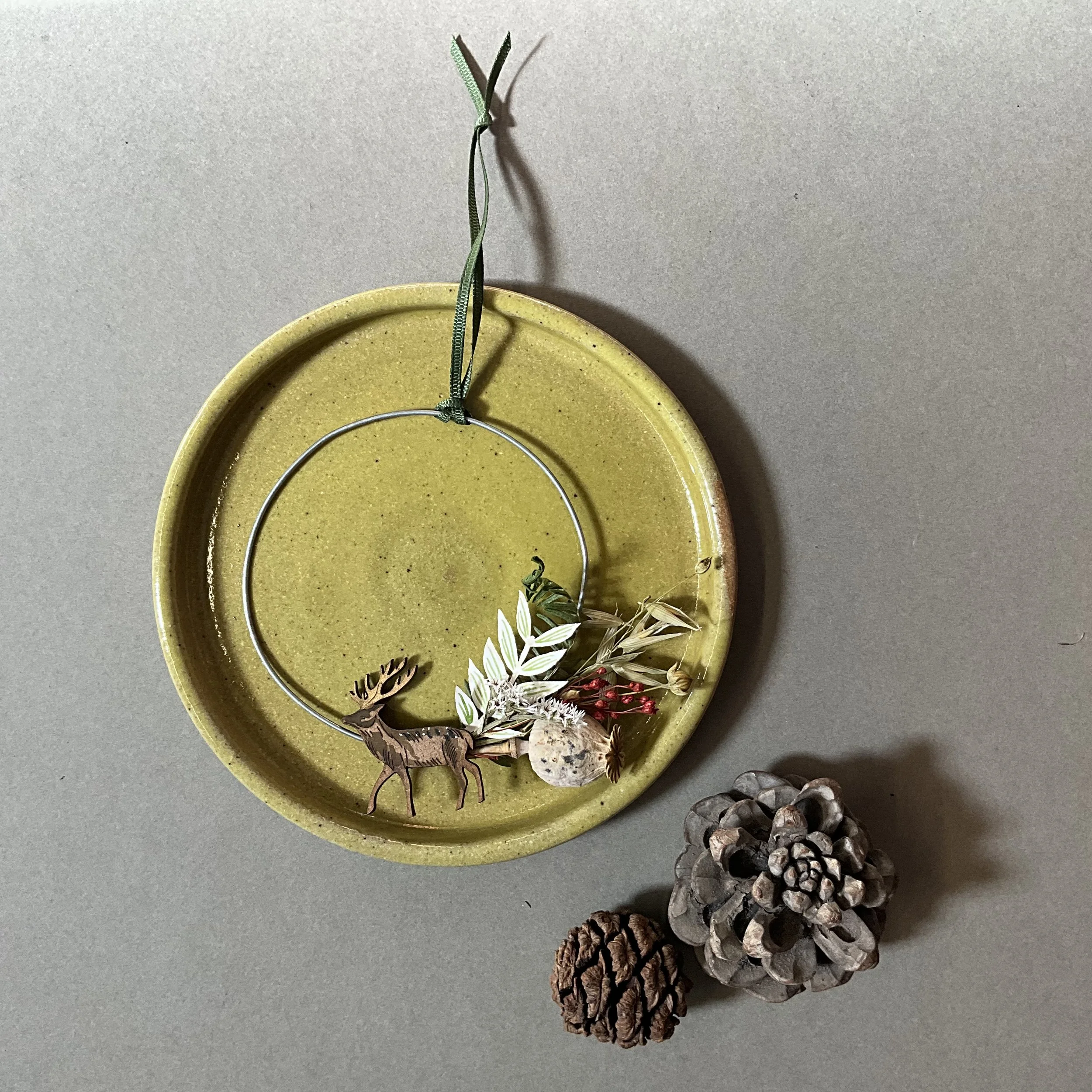 Dried seedheads and foliage with paper cut leaves mounted on a piece of steel wire. Lily Faith's small wreaths feature different woodland creatures including this stag (Copy)