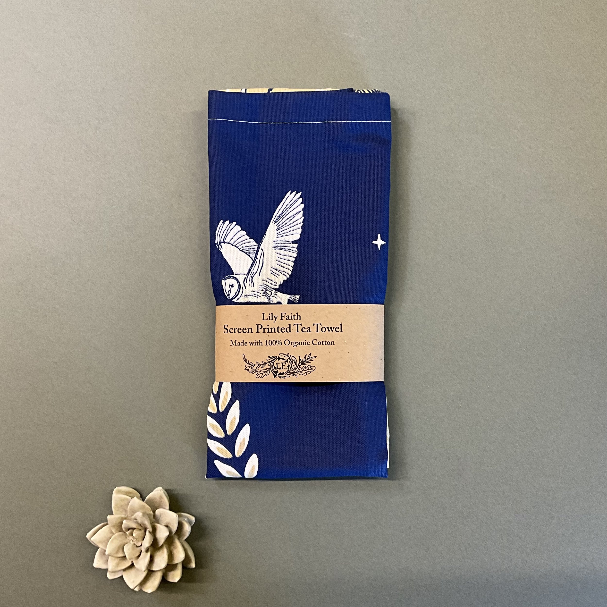 Lily Faith Moonlit Hare Tea Towel folded with a kraft paper band.