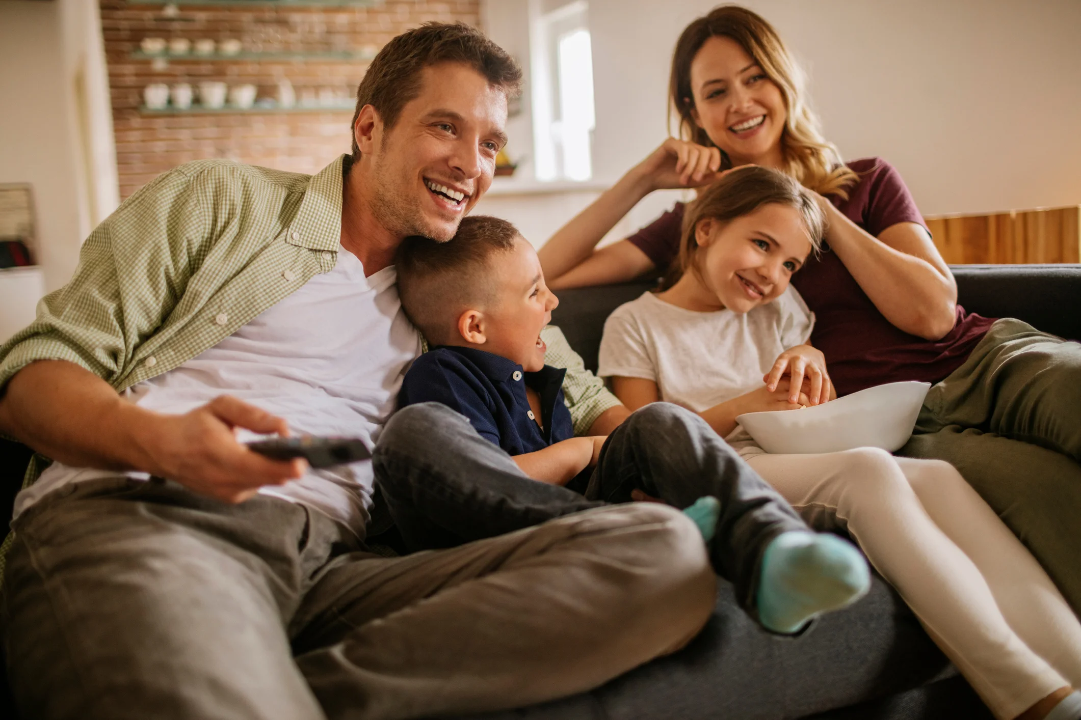 Playful-young-family-watching-television-520653076_2125x1416.jpeg