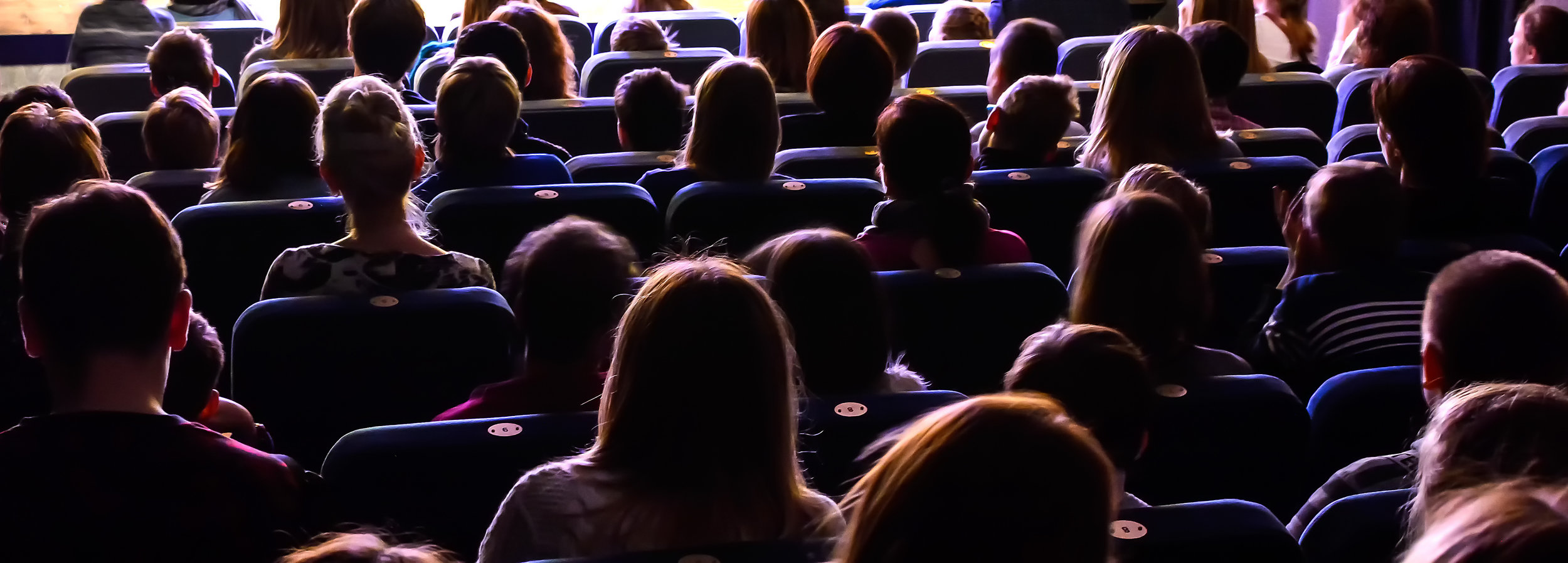 People-in-the-auditorium-watching-the-performance-886131824_4825x1732.jpeg
