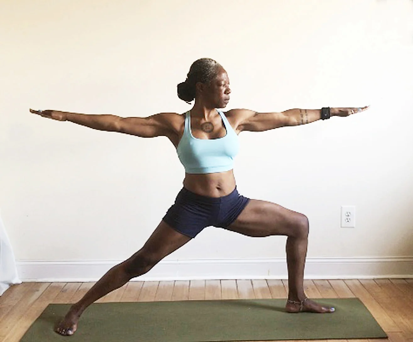 virabhadrasana II. (warrior two pose): shoulders over hips. back toes turned out.