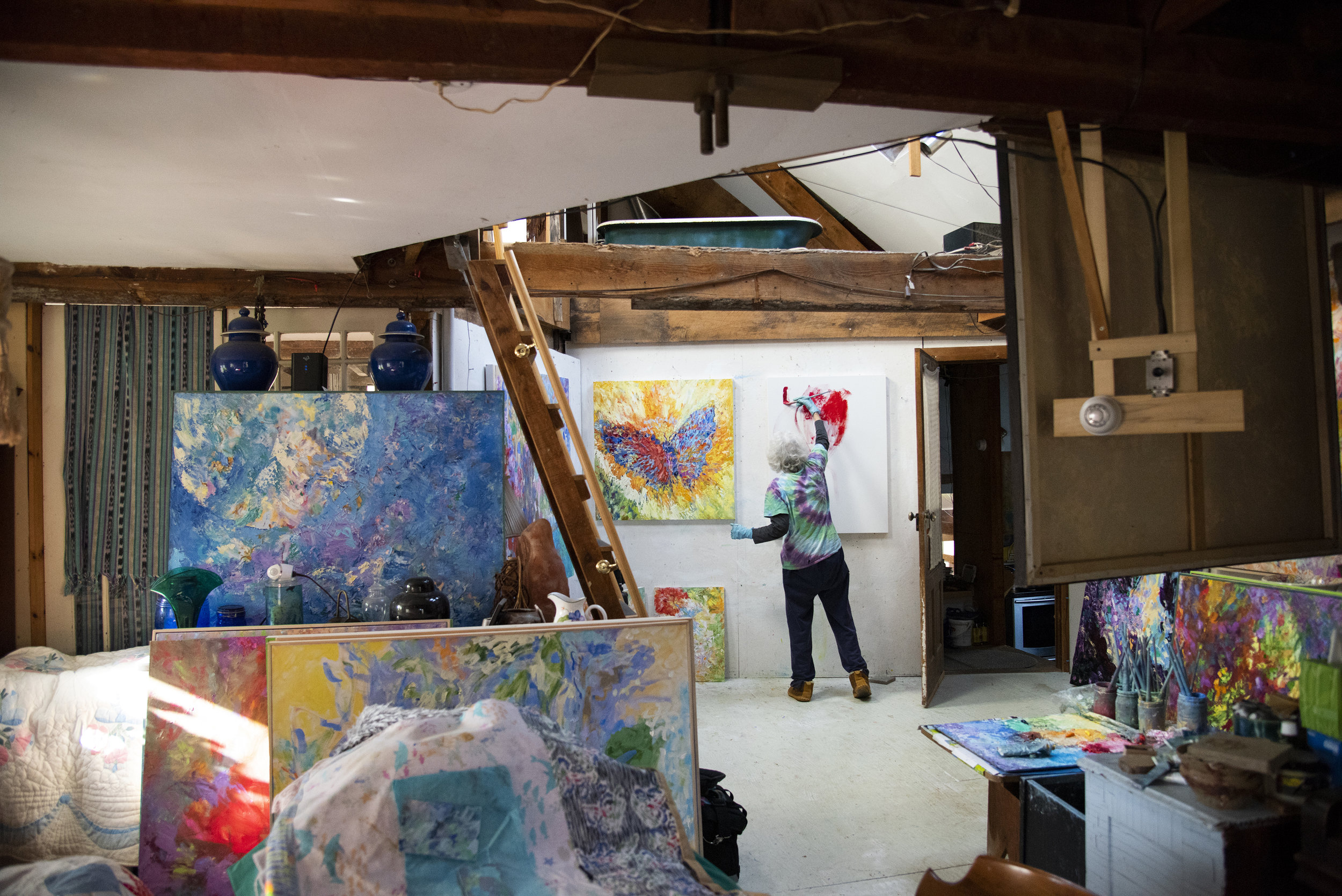 Jean Forsberg, a retired Penn State instructor, works on a painting in her Julian Woods home. Julian Woods is a small woodland community located in central Pennsylvania that has about 20 residents who live on shared land.