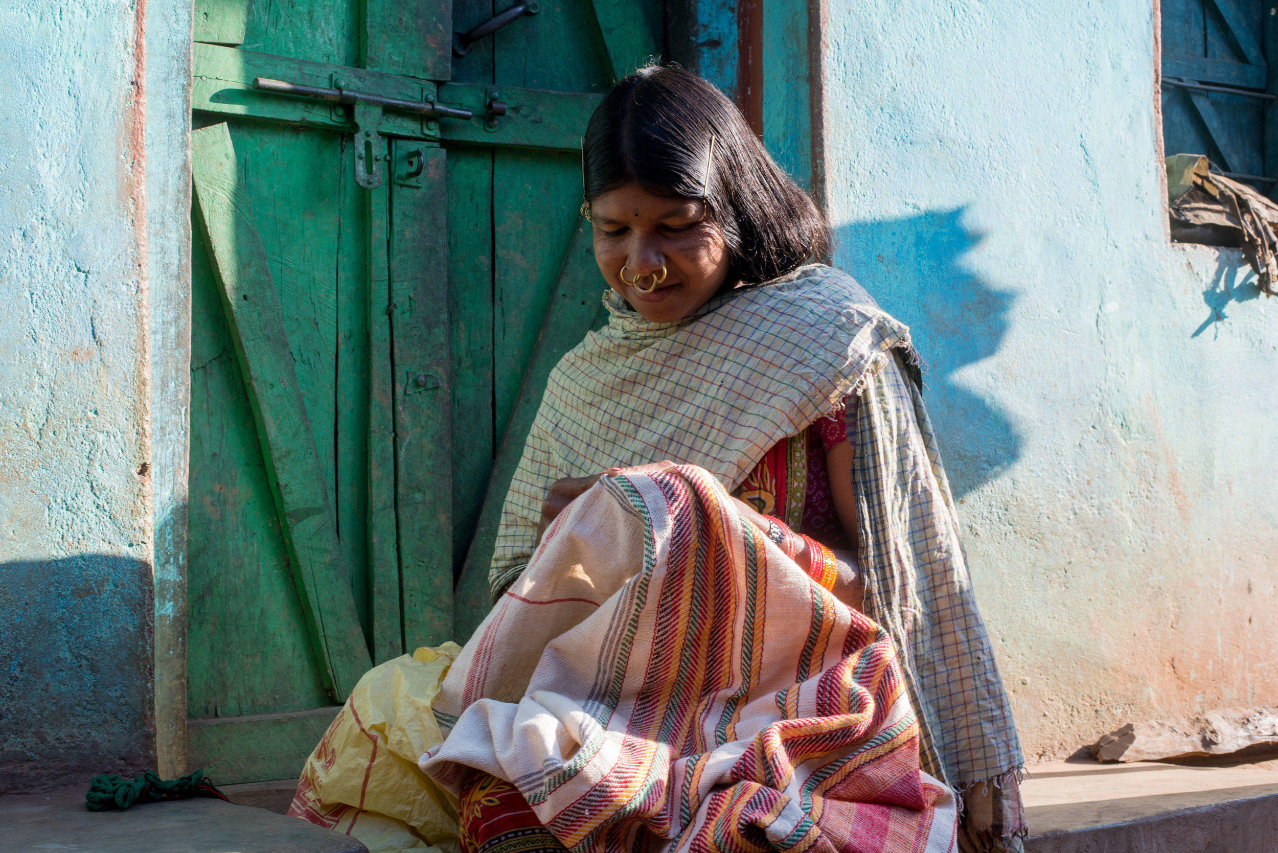 Dongria girl embroidering their traditional textile, 'Kapadagonda'.