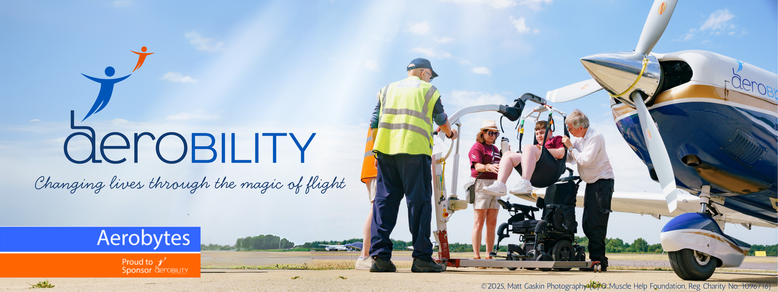Aerobility logo and phrase changing lives through the magic of flight. Picture of boy being hoisted out of his wheelchair into an aircraft.