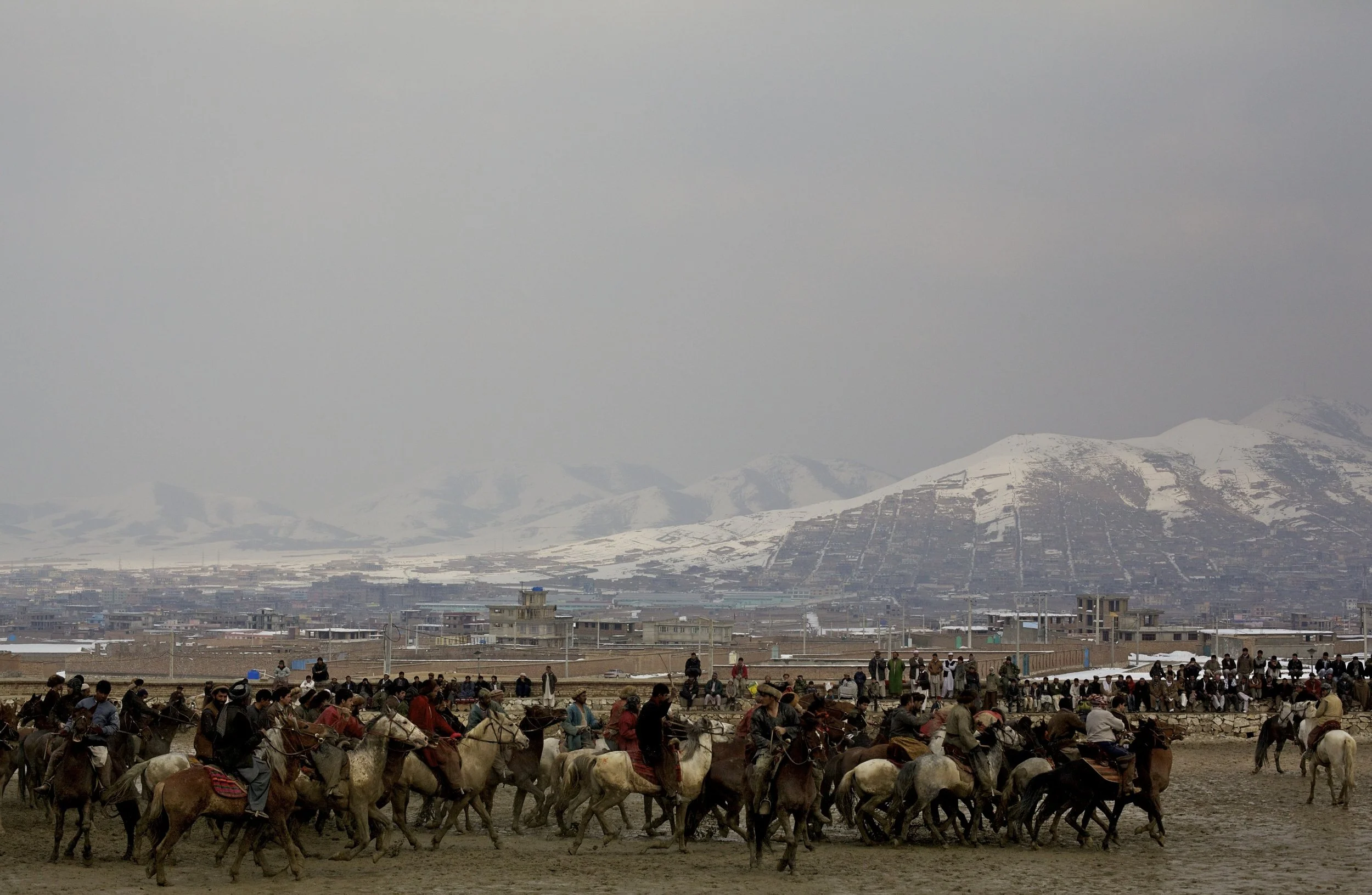  Horsemen of a buskashi match on the outskirts of Kabul, 2011. Buskashi, the national sport of Afghanistan, involves horse mounted players score goals with a goat or sheep carcass. 