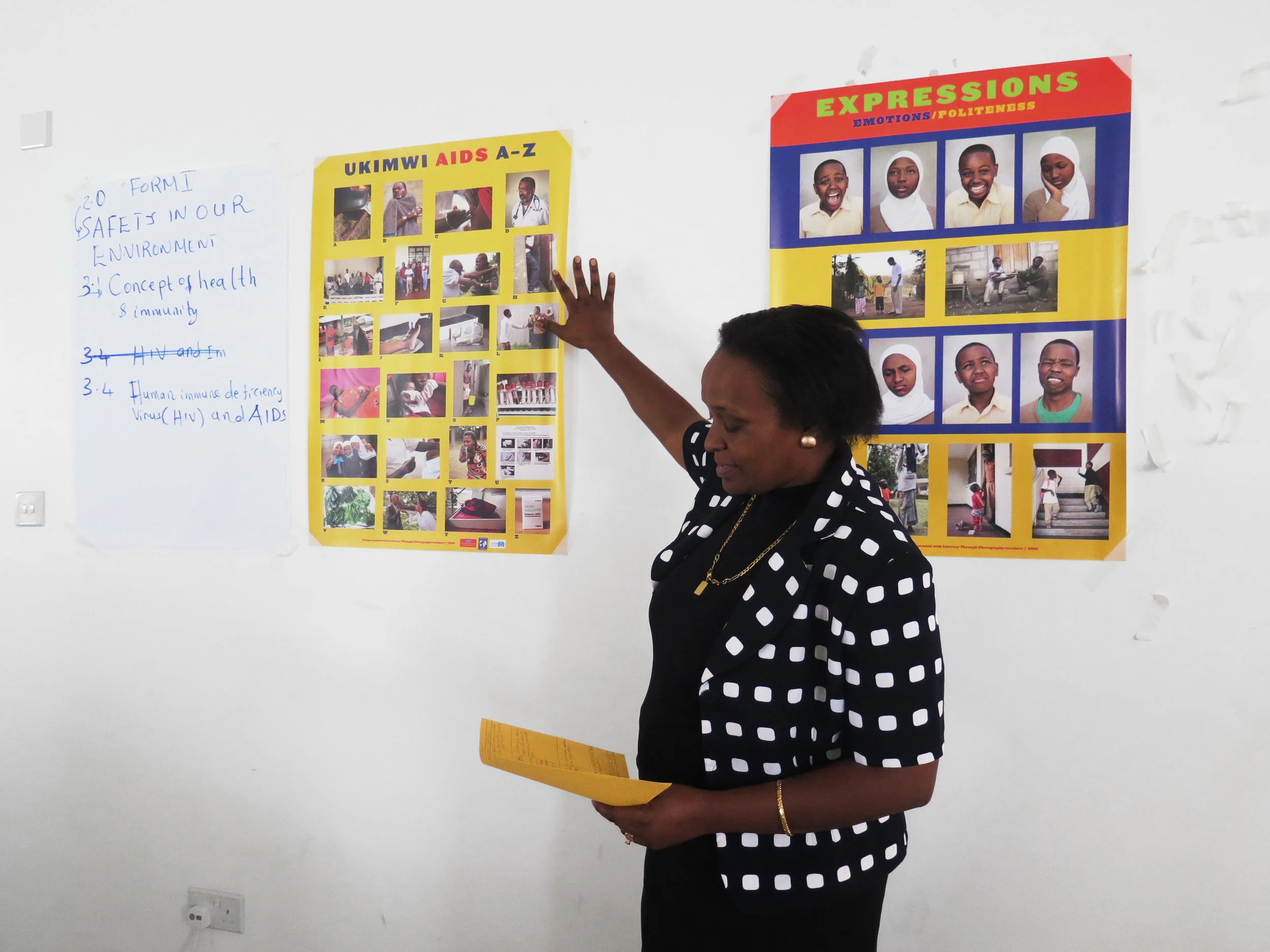 A Tanzanian educator works on adapting primary school TLTP posters for use in Tanzanian secondary schools