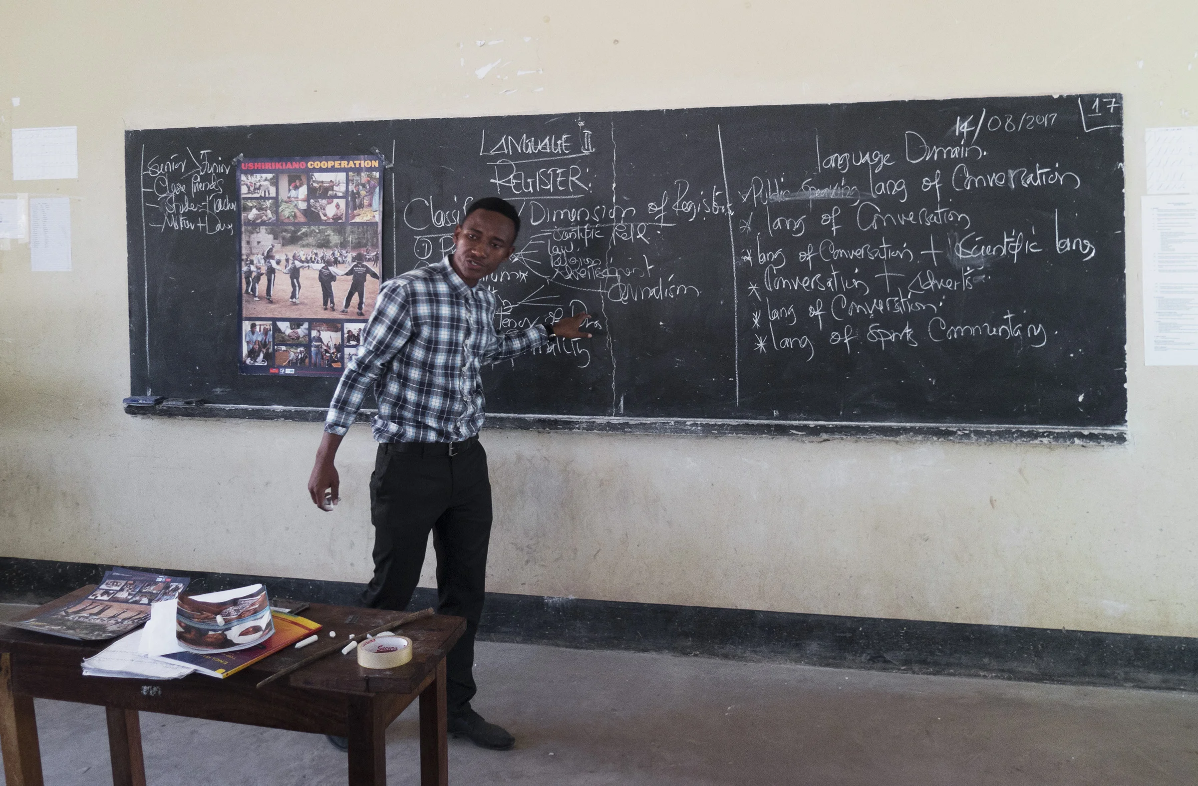 A student-teacher from University of Dodoma's Education program uses a TLTP poster during a classroom lecture.