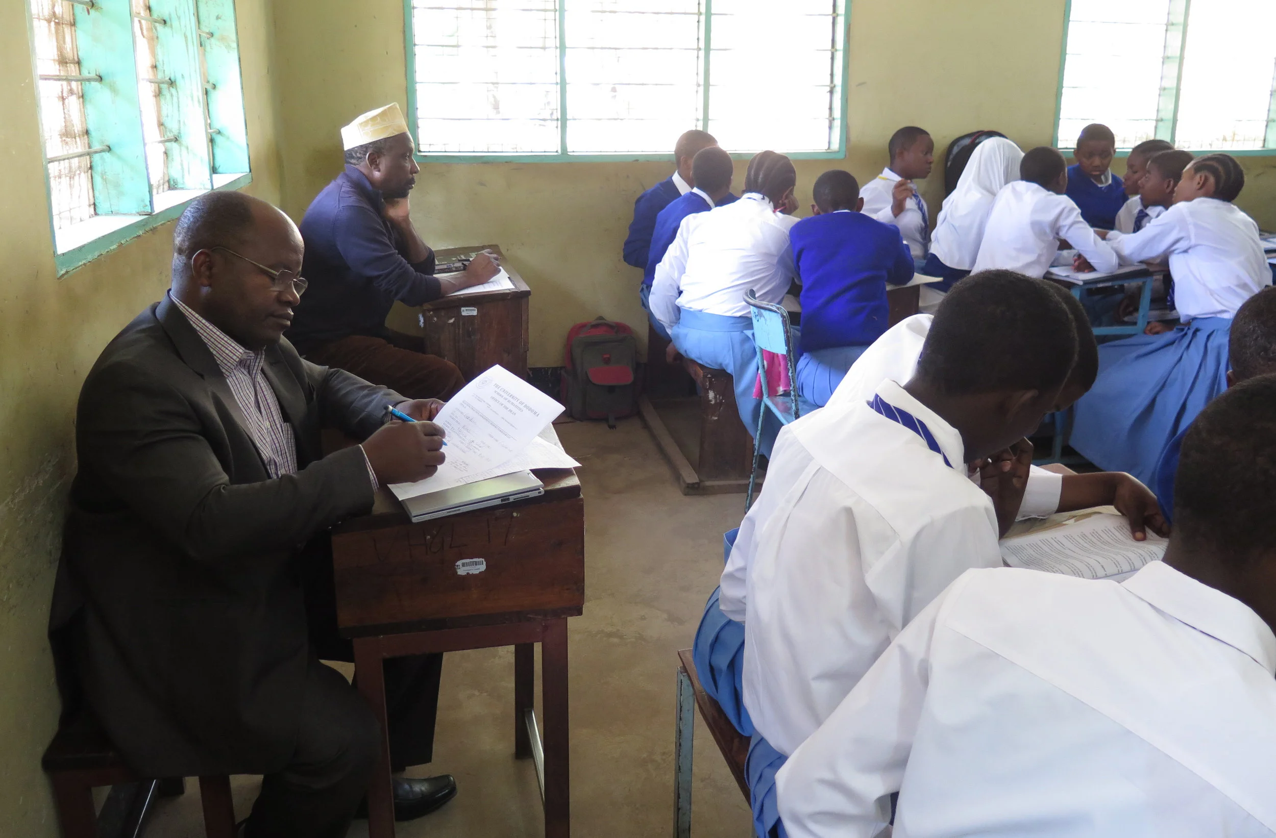 Dr. Frowin Nyoni, foreground left, evaluates a UDOM student teacher's use of TLTP methods.