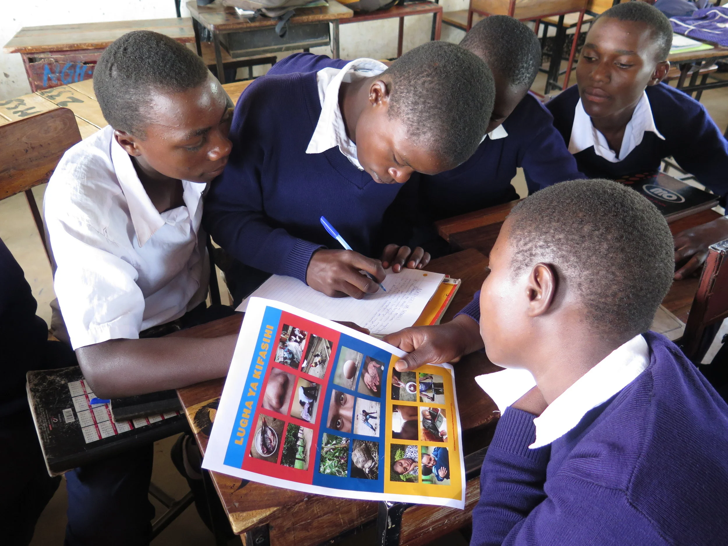 Secondary School students work in groups writing stories