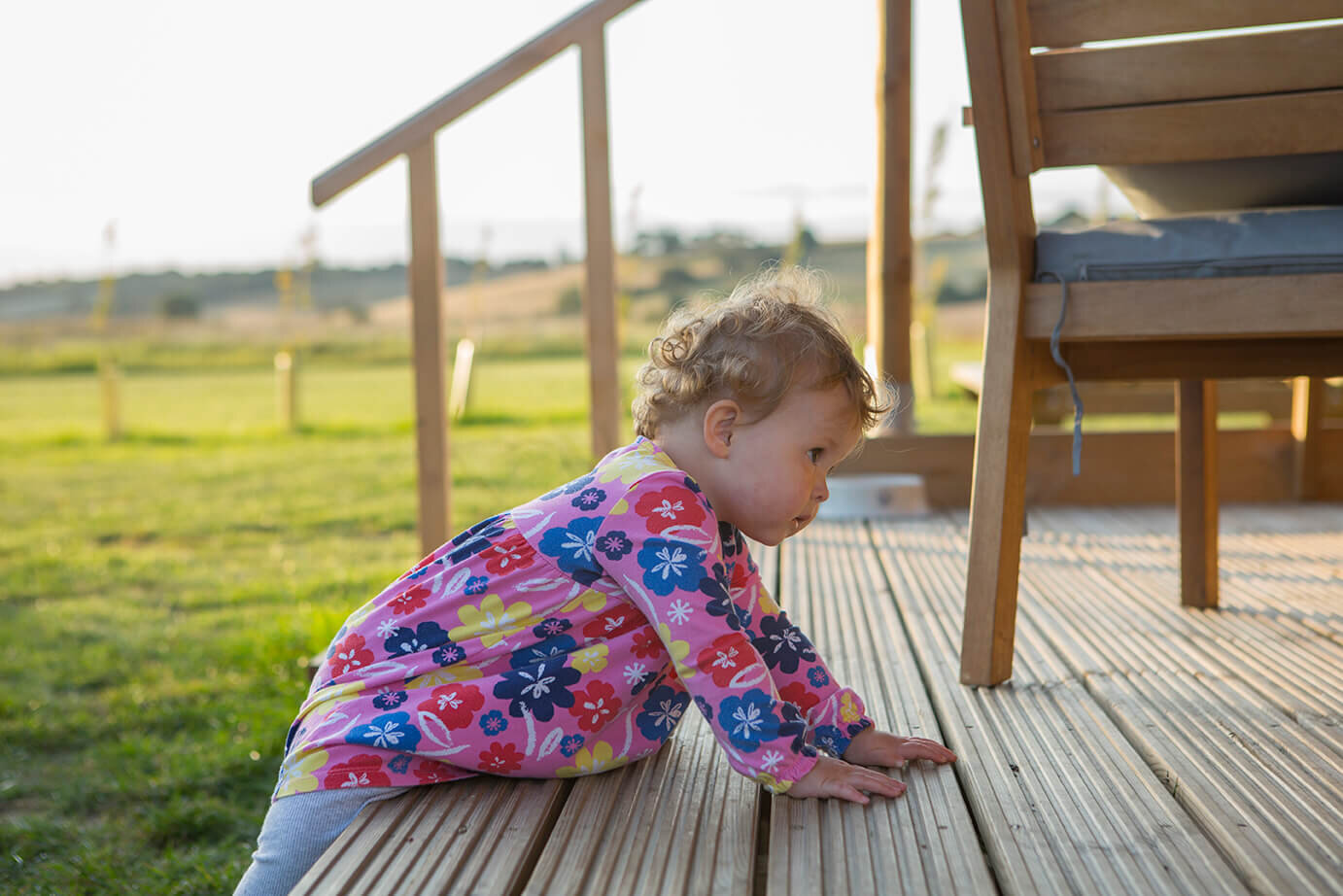 Baby climbing up step at Wheatfields Luxury Glamping