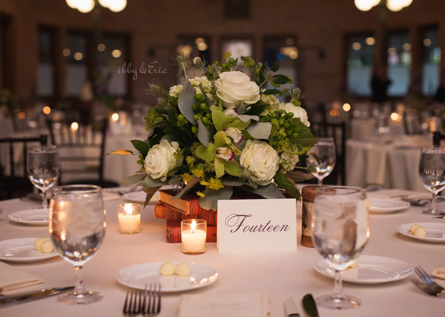 Wedding centerpiece with white roses and flowers with candles