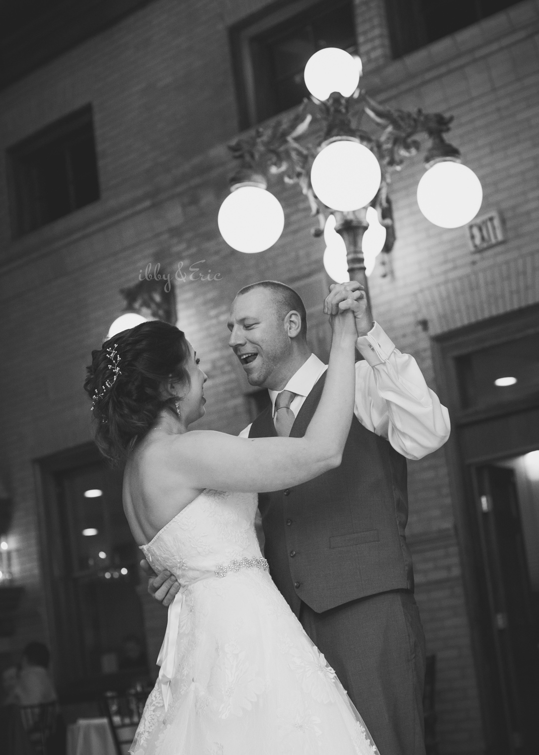 Groom sings to his wife during their first dance in front of a lamp post at Union Station Northampton.