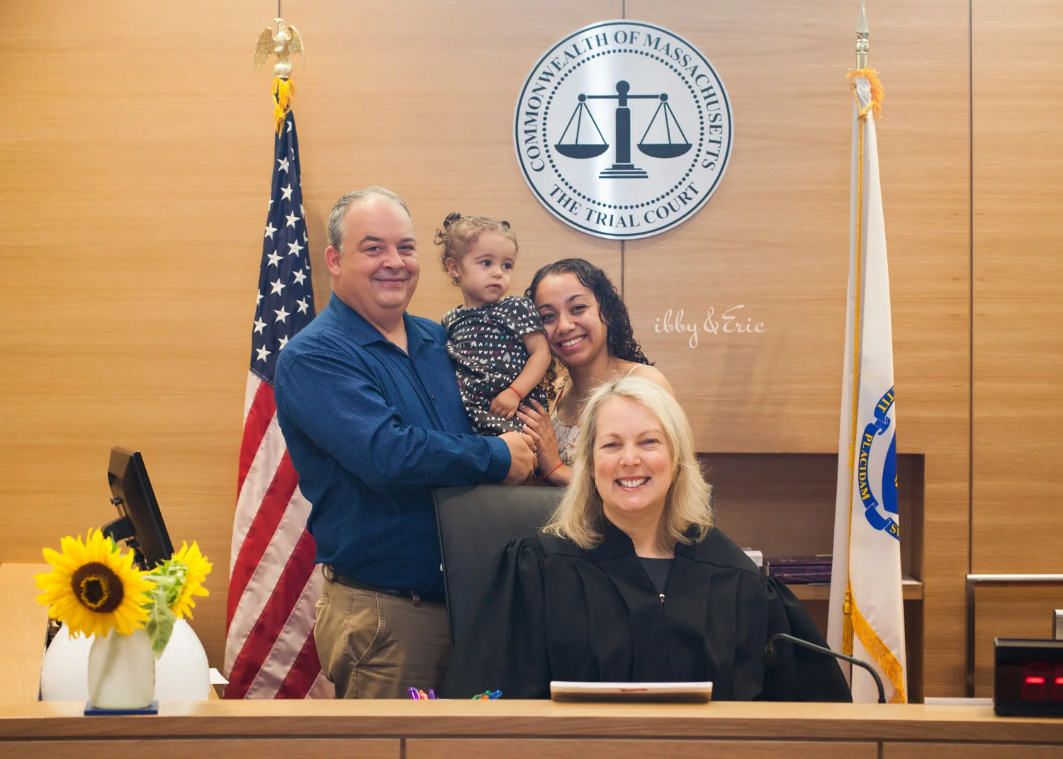 A Franklin County Superior Court judge poses for a photo with a happy family that just completed their adoption ceremony.