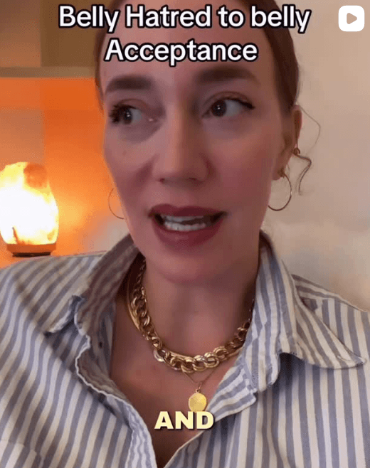Katherine Metzelaar speaking to the camera with text reading “Belly Hatred to Belly Acceptance.”
