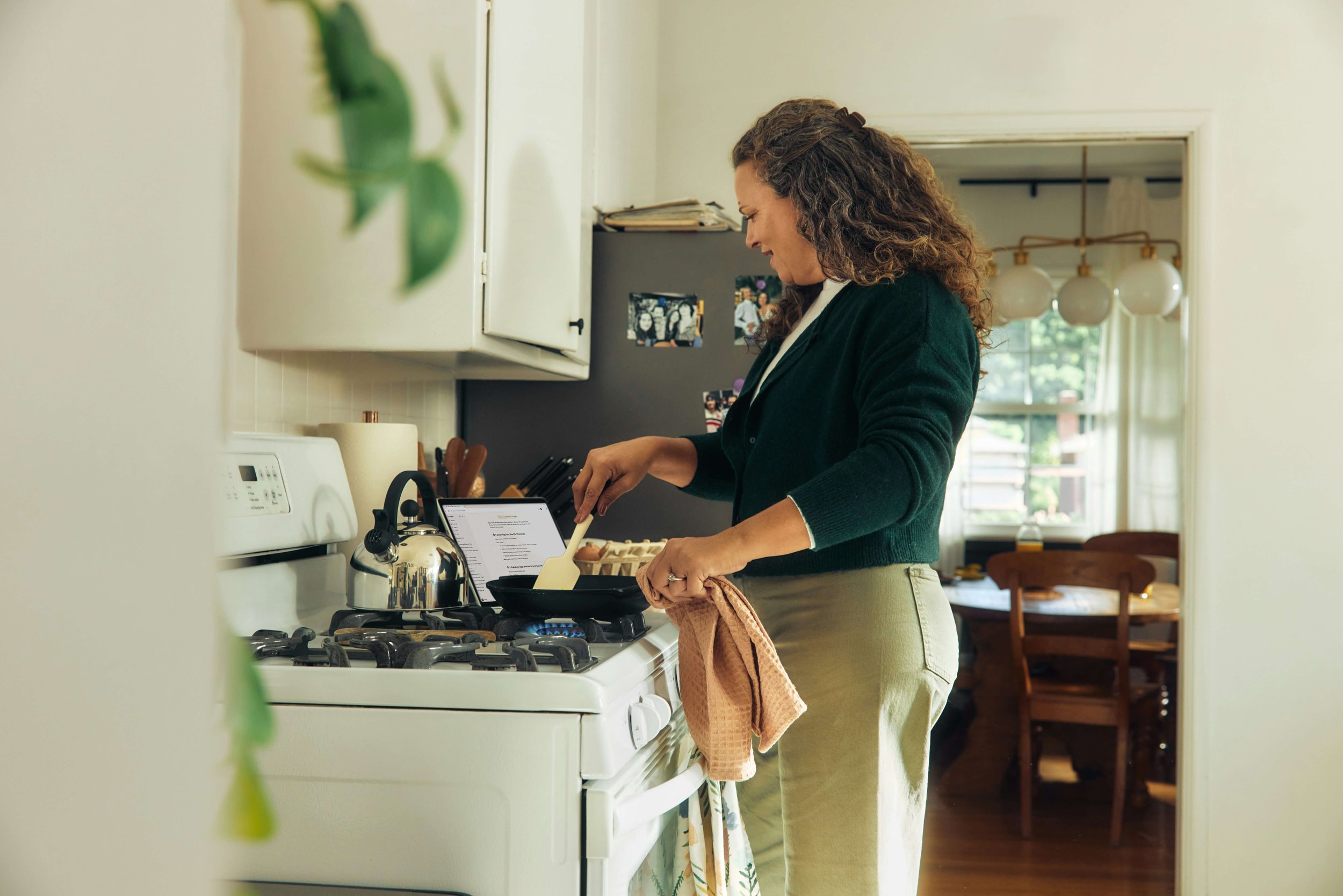 Person cooking food at the stove in a home kitchen