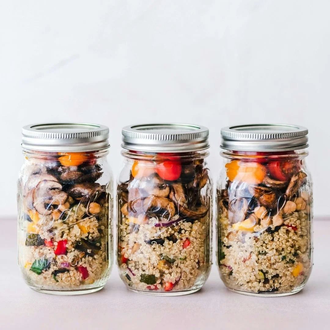Simple meal prep jars with quinoa, vegetables, and mushrooms, illustrating a flexible, non-diet approach to meal preparation without rigid food rules.