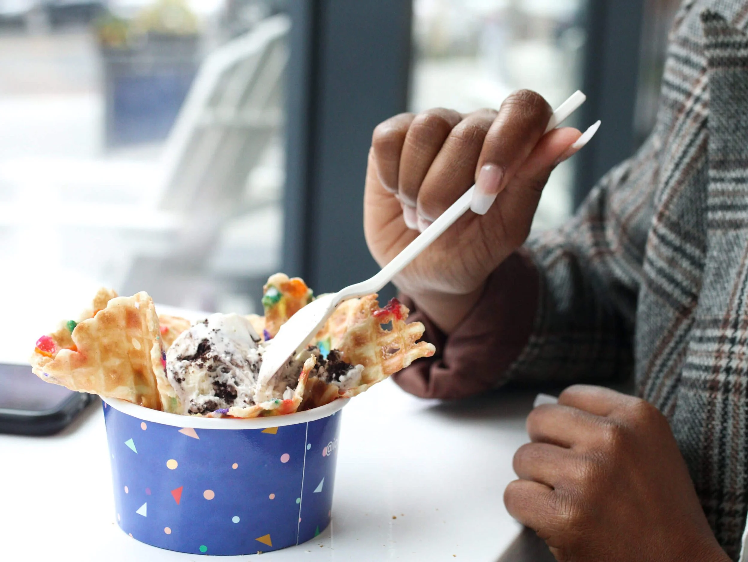 Person eating dessert at a table